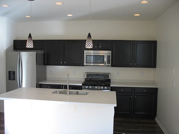 Kitchen w/ gas stove, fridge with water and ice in door all