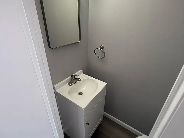 Newly renovated main floor bathroom with new vanity, mirror, and lights