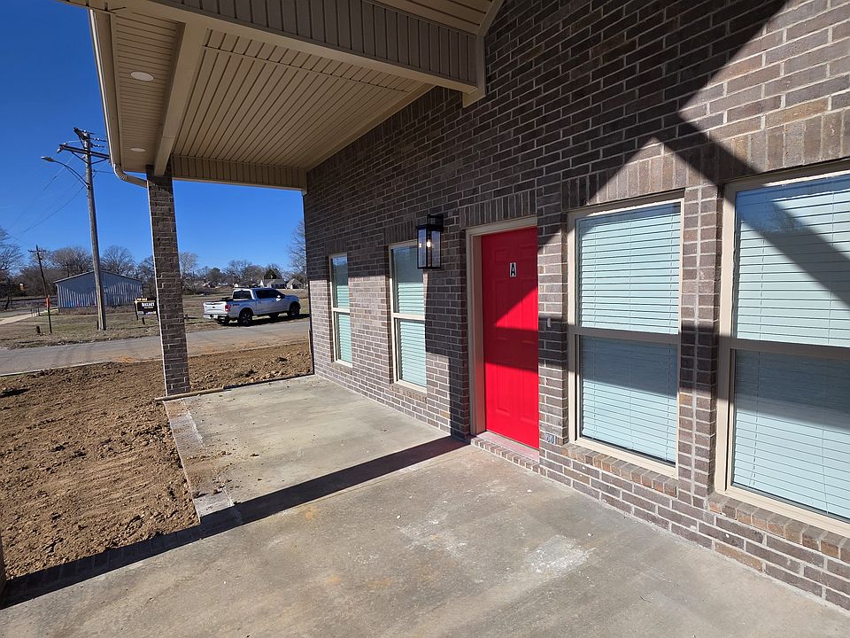 Full covered front porch with brick wall divider between units for privacy