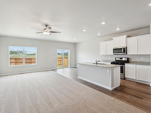 The kitchen in the Pike has white wood cabinets.
