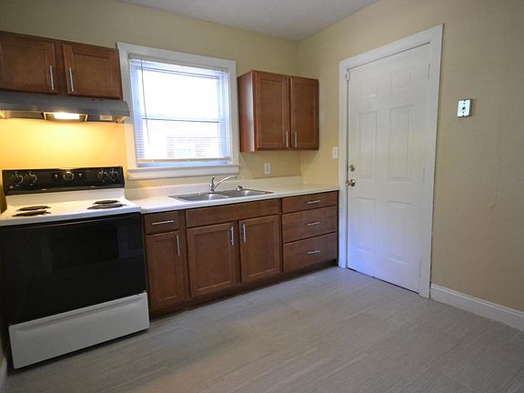 Kitchen has tile floor and pecan cabinets