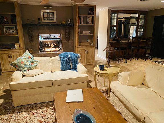 Part of 2nd floor living room with view of kitchen and dining nook through the dry bar area, also divided by gas fireplace.