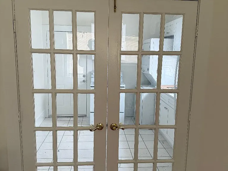 Closed French door that separate living room and kitchen.