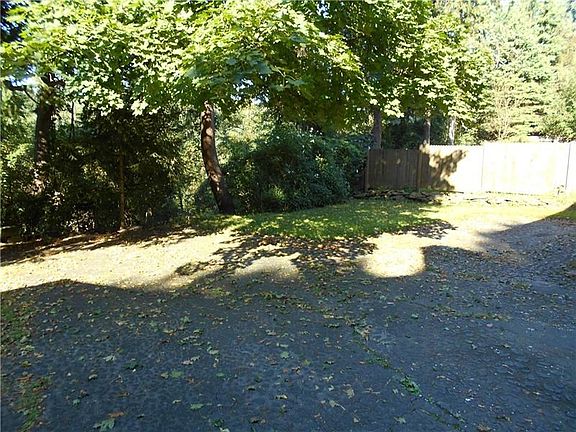 Spacious back yard adjoins a wooded area, and there is plenty of room to turn your car around.