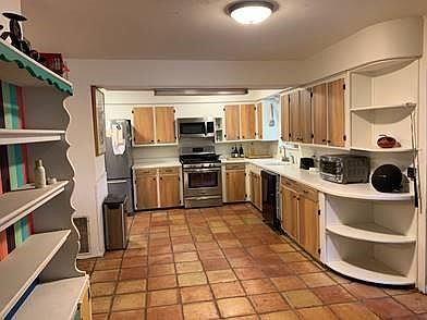 This large kitchen offers lots of counter space and has an open plan with an adjacent breakfast room.