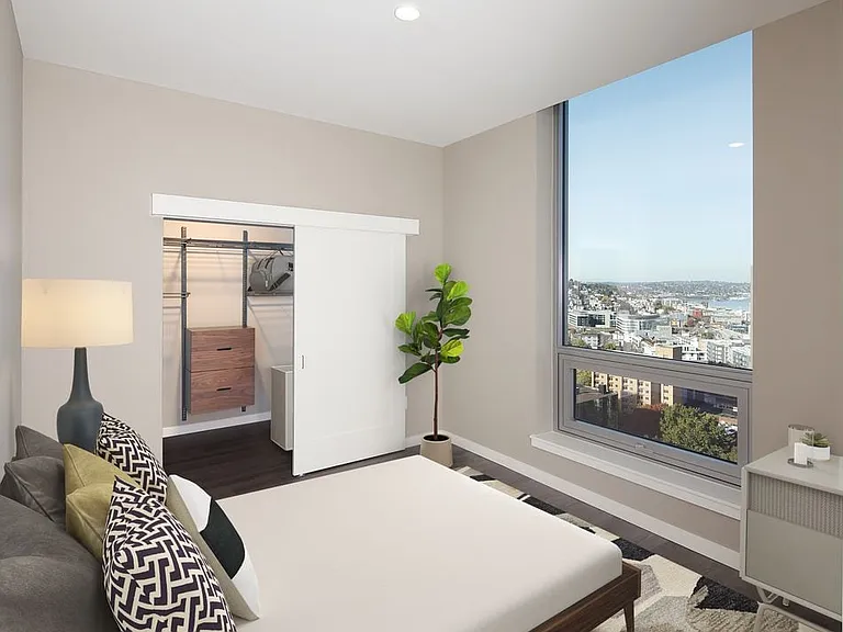 Signature Collection penthouse bedroom with floor-to-ceiling windows and hard surface flooring.