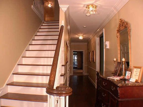 The front foyer is flanked by a formal living room and formal dining room. 