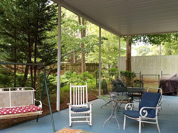 Large private patio in a peaceful, wooded scene.