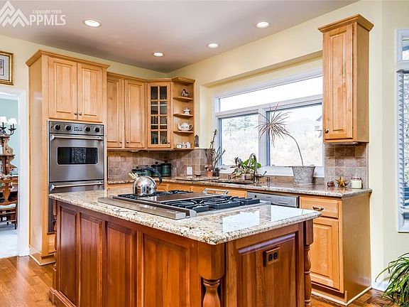Gas range, granite countertops, custom cabinetry.