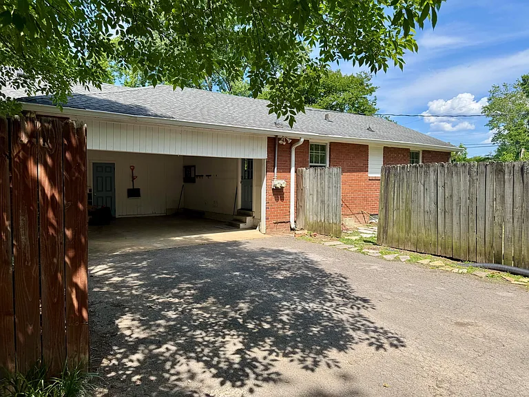 Back door entrance through carport.