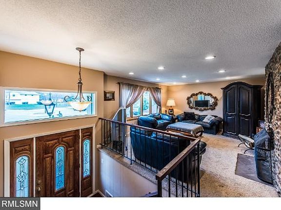 Entry way and view of front living room with fireplace.