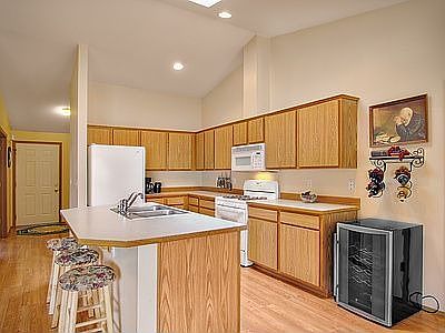 The kitchen is bright and open plus has plenty of cabinets and an island count