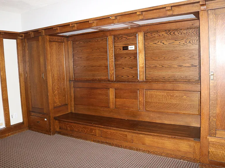 Built-in shelving units in the living room- with storage under the bench