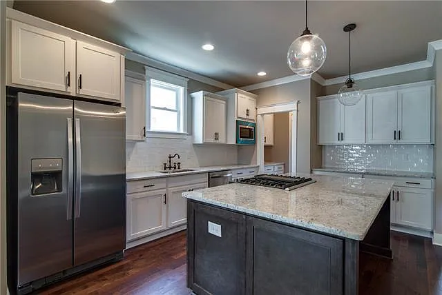 Entertainers dream kitchen. Jenn Air range in the center of the island so you can cook meals while conversing with guests.