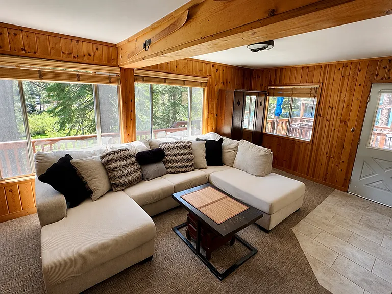 Cozy living room with wood-burning stove and forest views