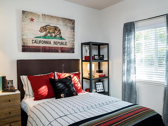 Guest Bedroom with Framed Wall Decor and Natural Lighting