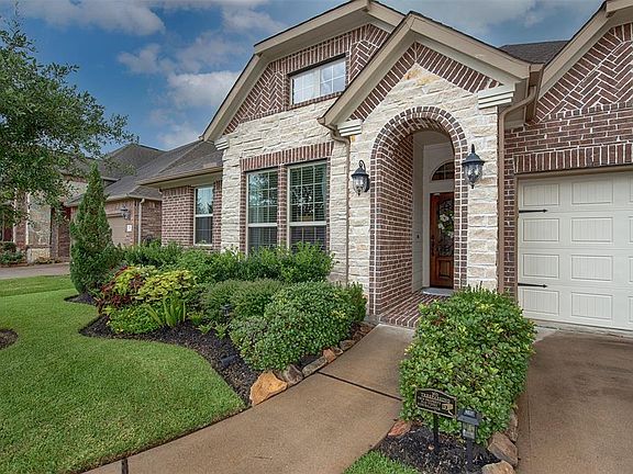 A closer look at the stunning landscaping with stone accents. Wonderfully inviting for your guests.