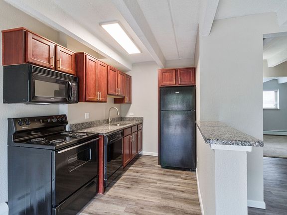 Large kitchen featuring granite countertops, a built-in microwave, and a dishwasher