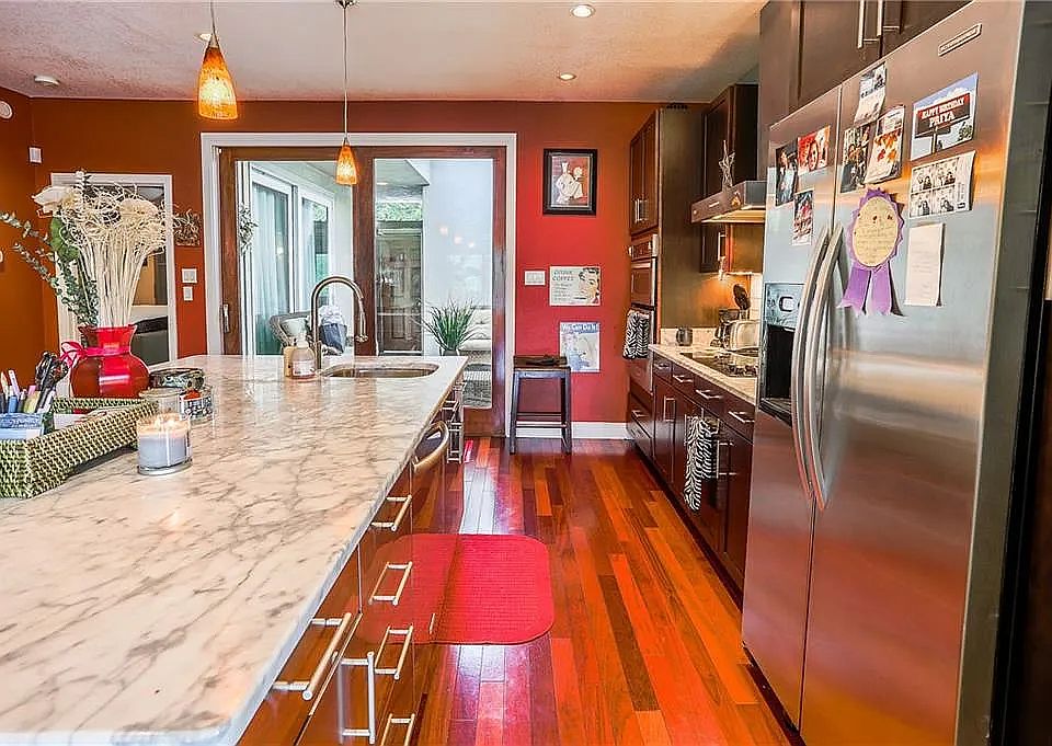 kitchen with marble top facing living room