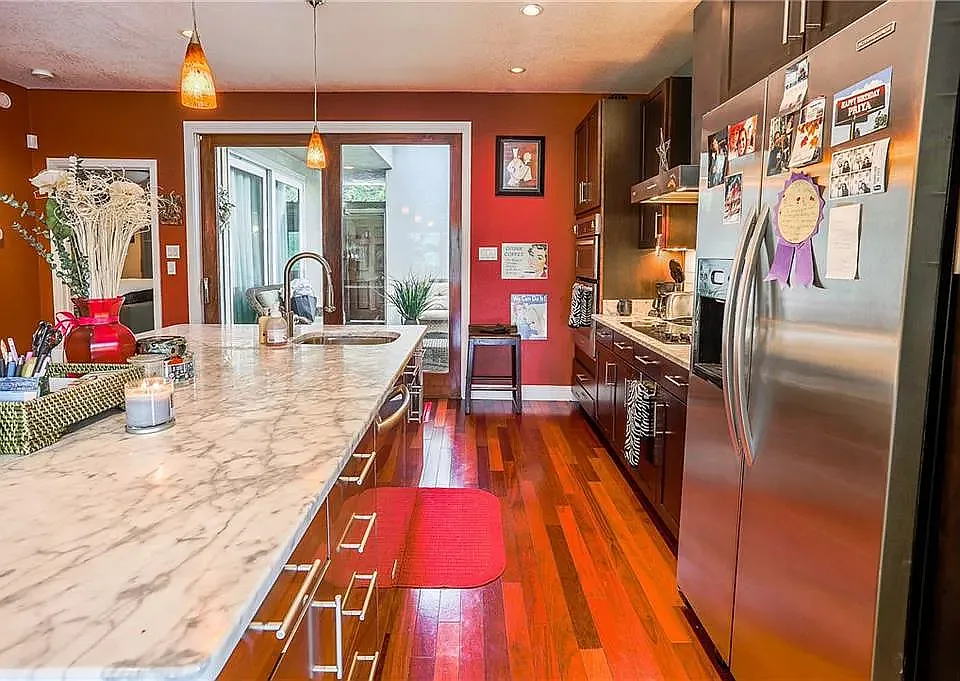 kitchen with marble top facing living room