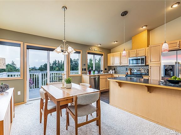Looking from Living Space into Dining Room & Open Kitchen.  Slider to Deck w/Wonderful Views of Surrounding Mountains & Valley - Efficient Sun Screen Shades on Windows & Slider. 
