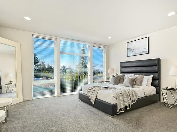 Primary bedroom with floor to ceiling windows