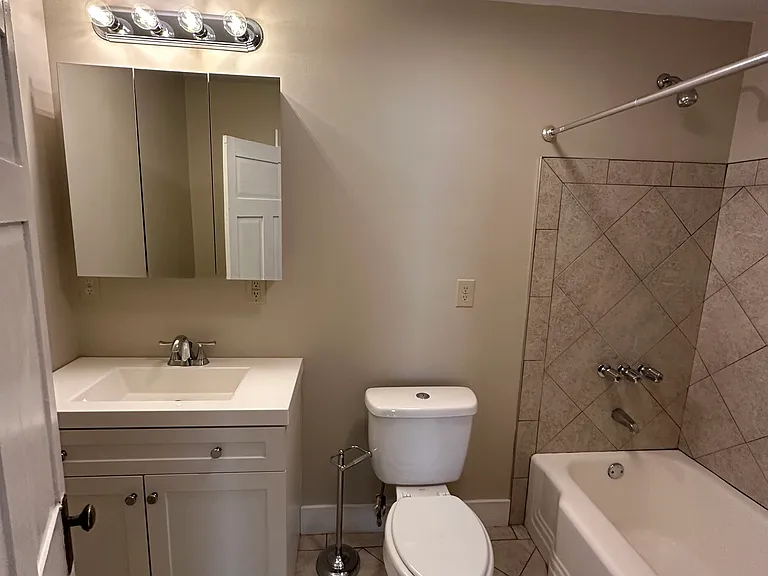 Bathroom 2. Tile floors and tub backsplash.