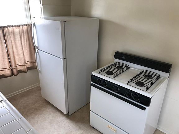 Broom closet next to the fridge