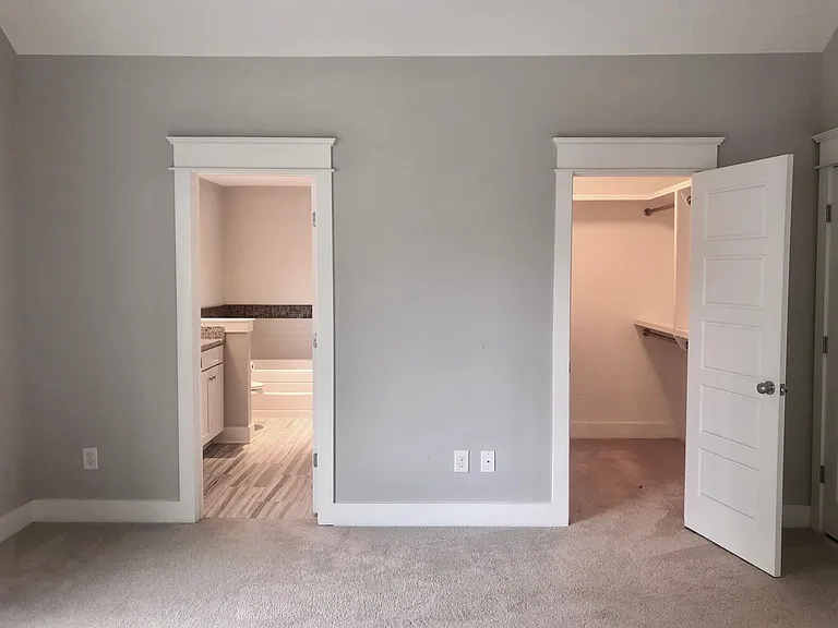 Primary Bedroom walk in closet & large bathroom with tub