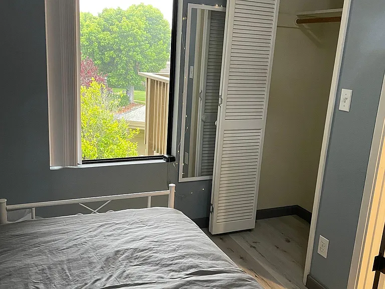 Third bedroom with closet and front yard view