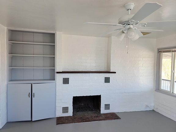 living room with fireplace and built in bookcase