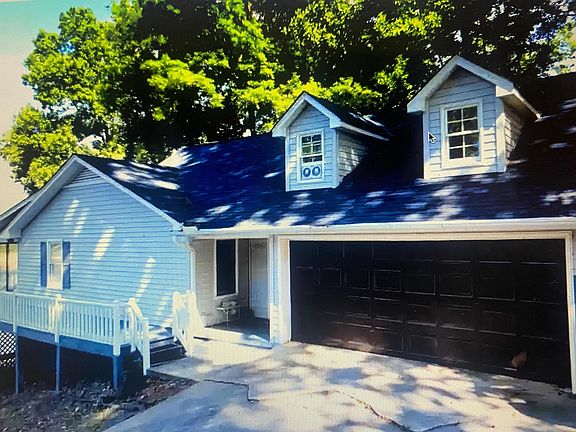 Front of House with oversized 1 car garage. Decorative Matching Steel Front Door. Wrap around deck.