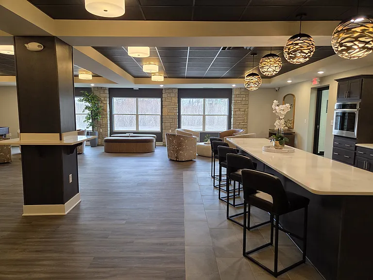 Community space at the clubhouse with a variety of seating, games, and kitchen.