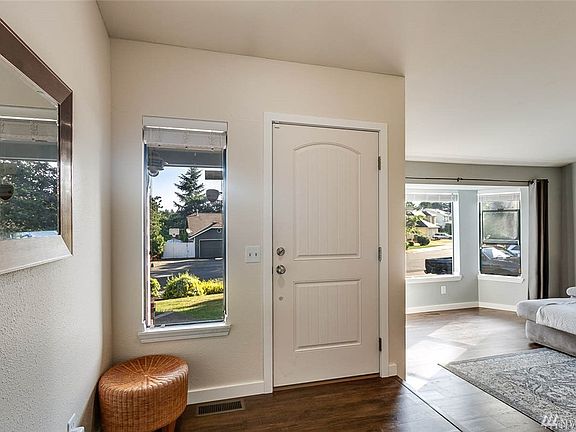 The foyer is spacious and bright! All doors and trim have been updated, and the home features gleaming floors and new carpet throughout.