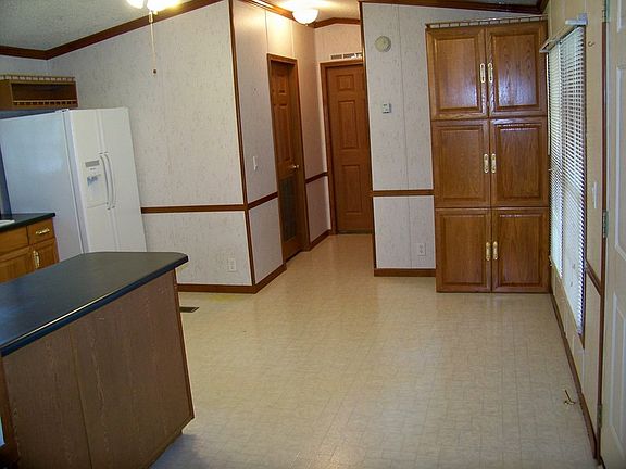 West side of the kitchen
						:
						Observe the solid oak cabinets and 6 panel interior doors throughout