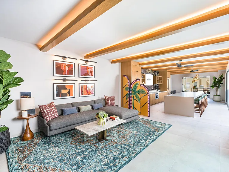 Expansive rooftop clubroom with demonstration kitchen and gathering spaces opening to the rooftop deck.