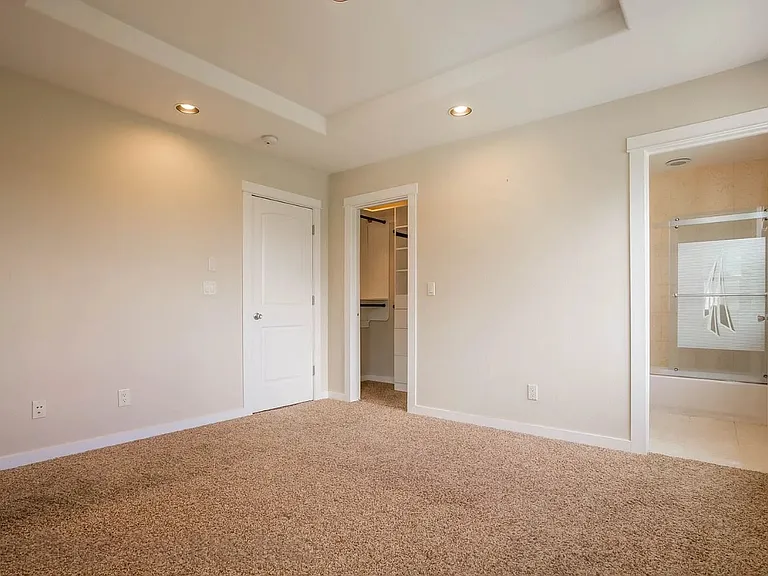 Primary bedroom with walk-in closet, and full bath. New wool carpet installed since this photo was taken.