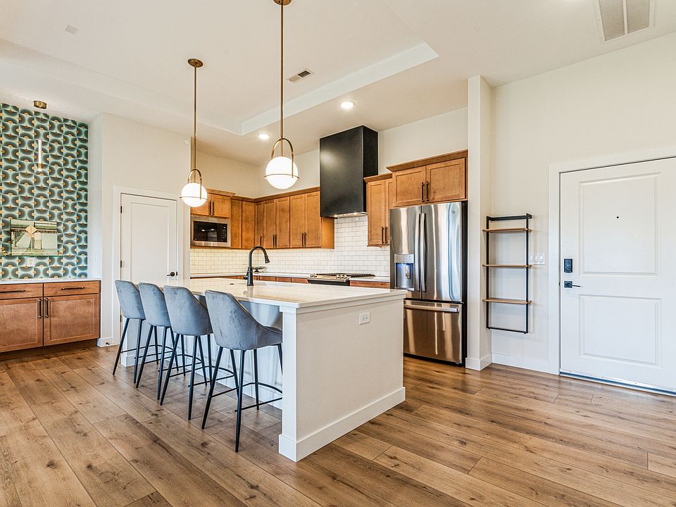 Seating at the island for four. Bar area with storage to left of island.