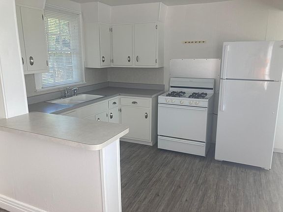 Breakfast bar or homework area. There is a small breakfast area and a pantry located to the right side of the refrigerator.