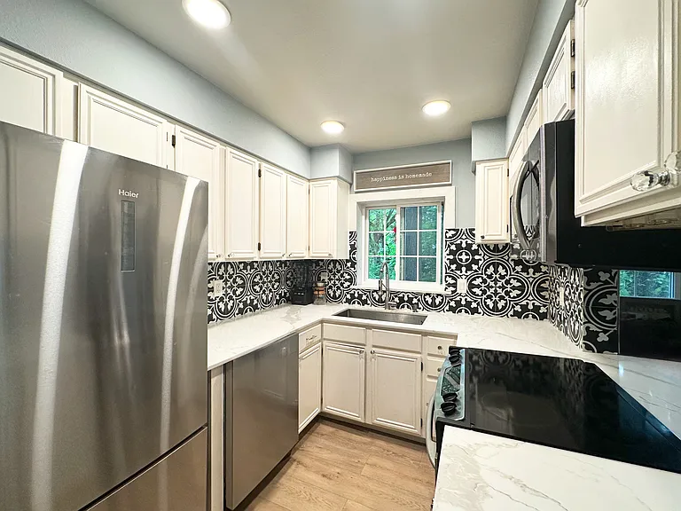 Granite countertops with stainless steel appliances.