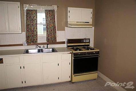 Nice sized Kitchen. Wood cabinets could look really nice refinished