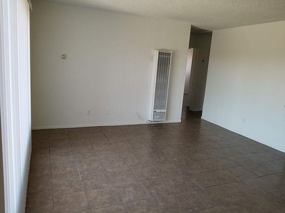 Large living room with lots of natural lights and wall heater