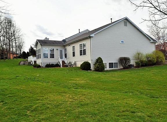 Back and side view of home. Lookout lower level windows.