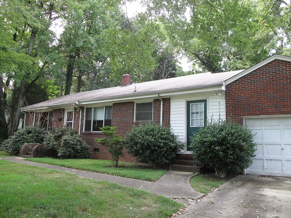 Front of the house showing front and breezeway doors. Single car garage.
