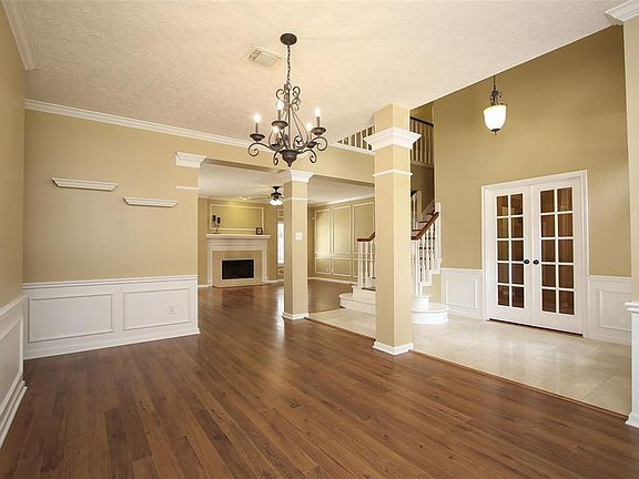 To the left of the entry is this open formal dining room with contrasting wainscoting, chair rail and picture frame molding.