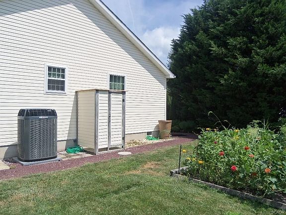 Outside shower and flower garden in side yard.