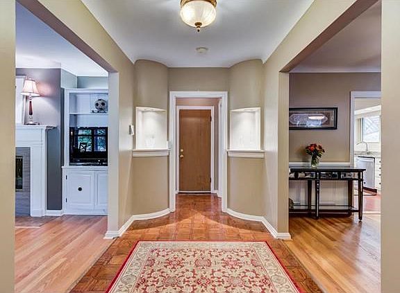 Inviting entry foyer with lighted artwork niches
