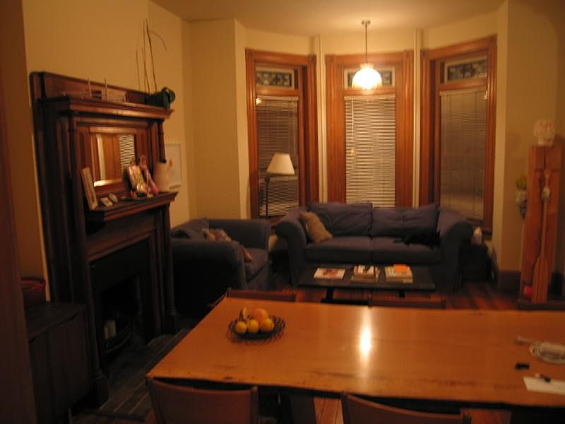 Past night time picture of bay window and fireplace mantle.