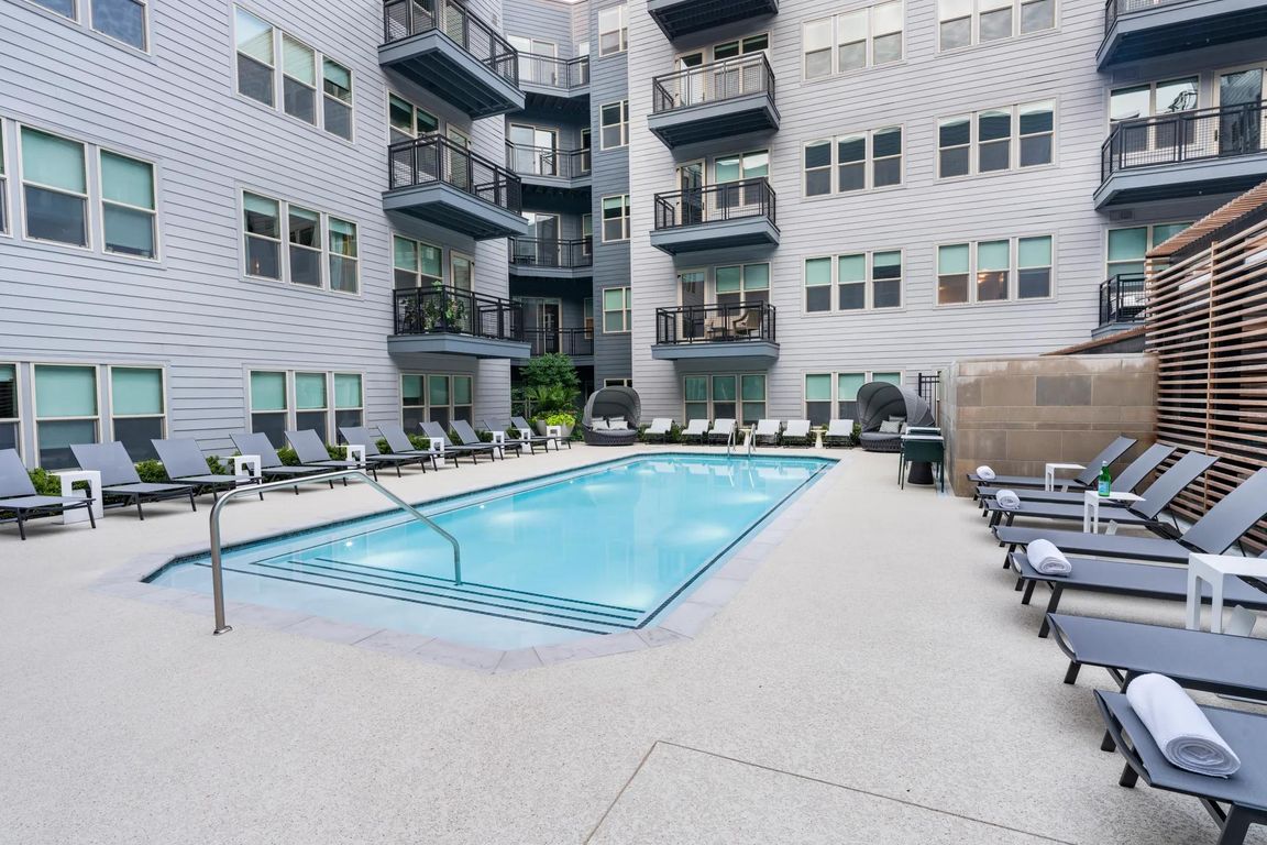 Relax by the sparkling courtyard pool_perfect for a refreshing dip or unwinding in a private lounge chair.
