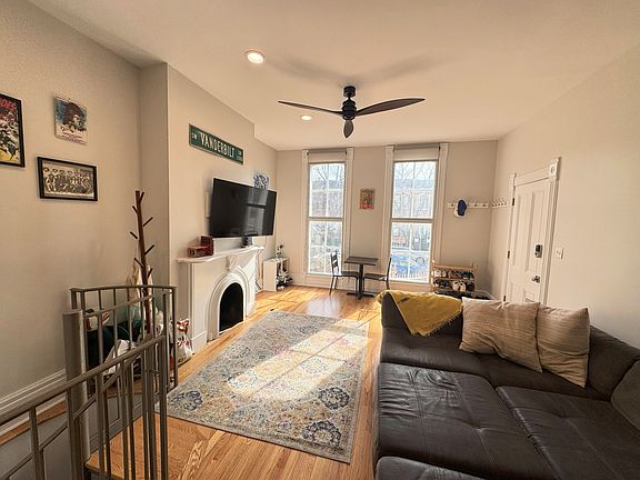 Closer living room view with the spiral stairs to the second level.